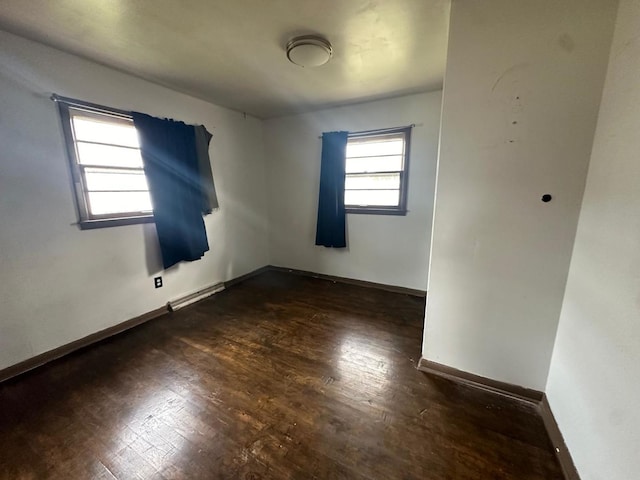 spare room featuring dark hardwood / wood-style floors