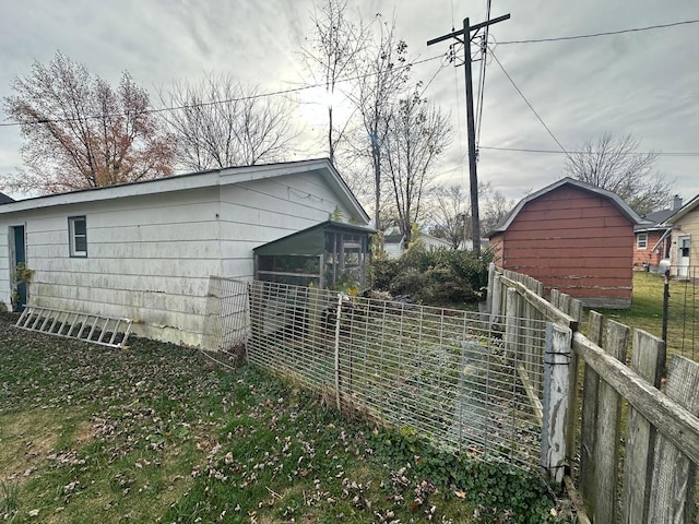 view of side of home with an outdoor structure