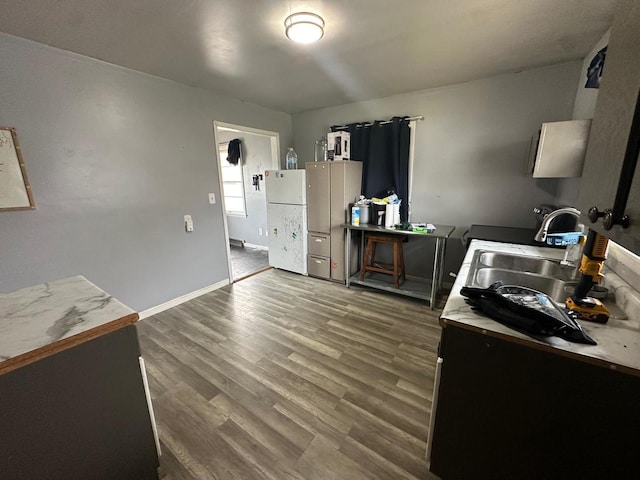 kitchen with dark hardwood / wood-style floors, white refrigerator, and sink