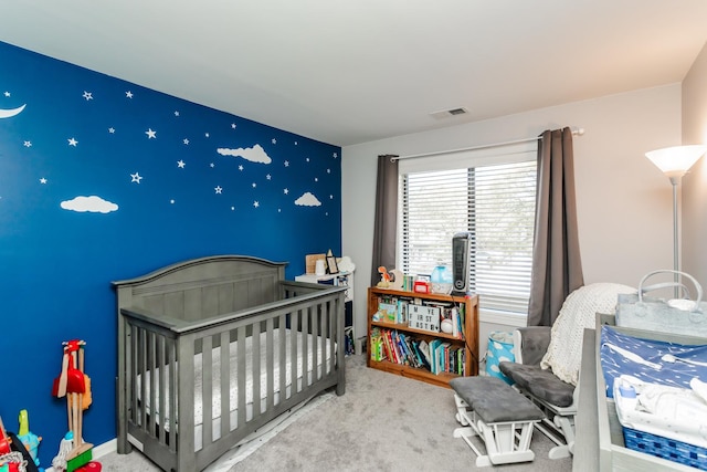 bedroom featuring carpet floors and a nursery area