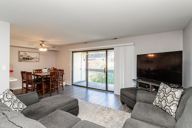 living room featuring wood-type flooring and ceiling fan