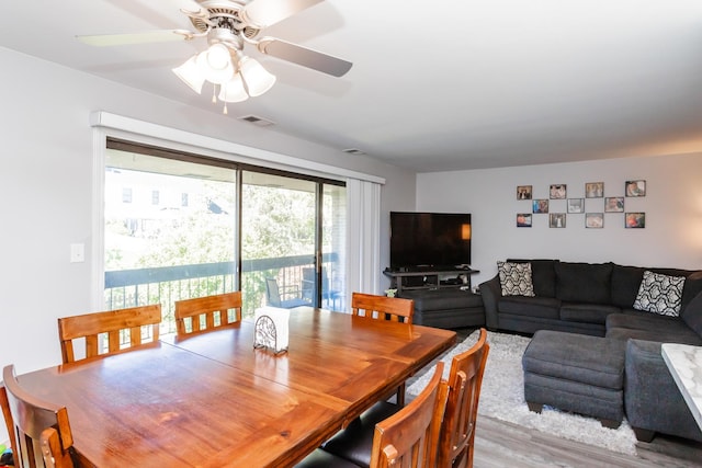 dining area featuring hardwood / wood-style flooring and ceiling fan