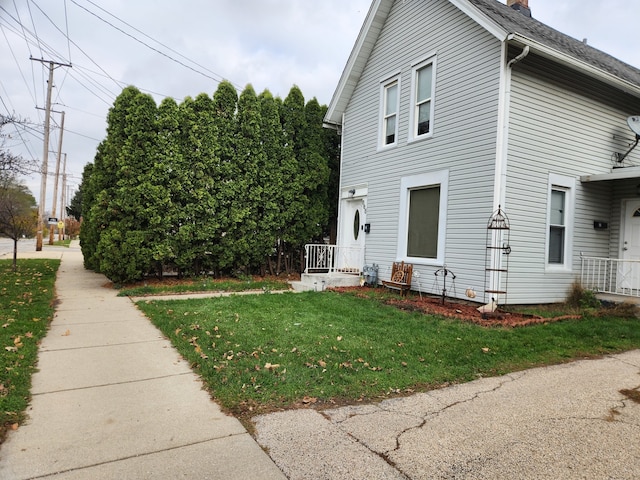 view of side of home featuring a yard