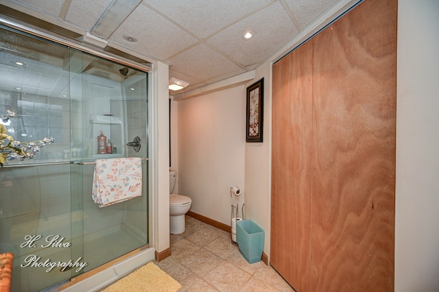 bathroom with a shower with shower door and toilet