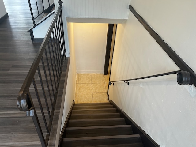 stairs featuring wood-type flooring