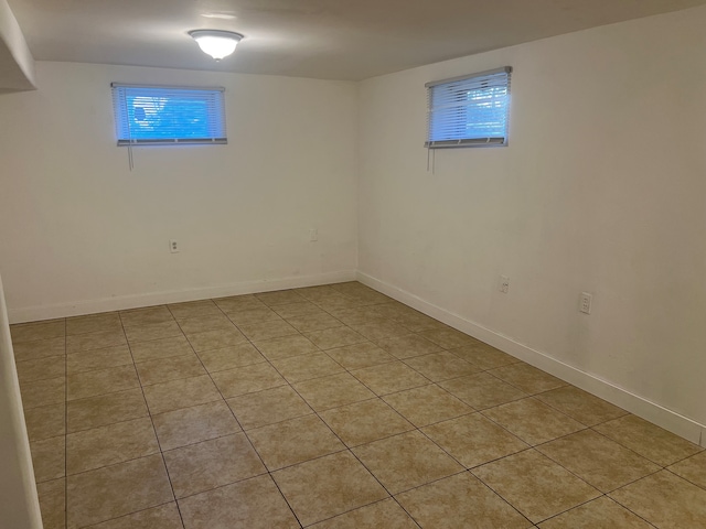 basement featuring light tile patterned flooring and a wealth of natural light