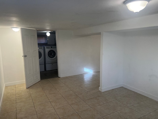 laundry area with cabinets, light tile patterned flooring, and washing machine and dryer