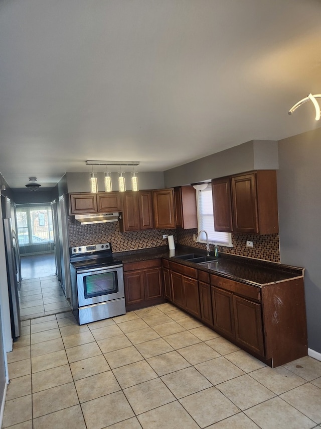 kitchen with light tile patterned flooring, appliances with stainless steel finishes, and sink