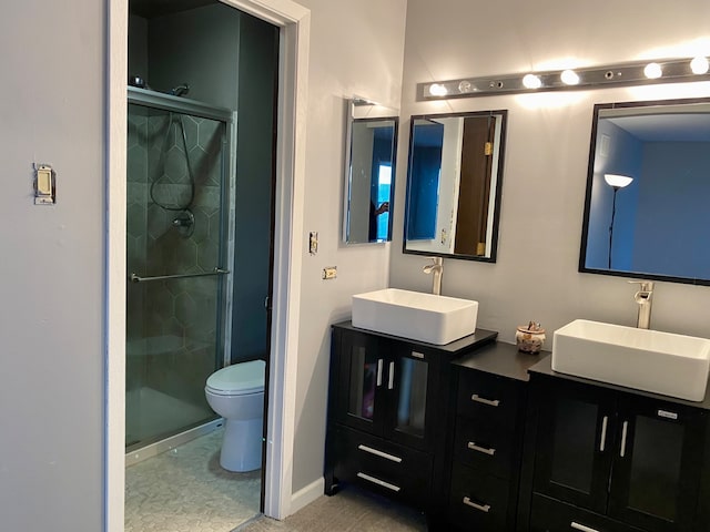 bathroom with tile patterned floors, vanity, toilet, and walk in shower