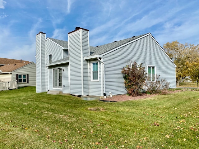 rear view of house with a lawn