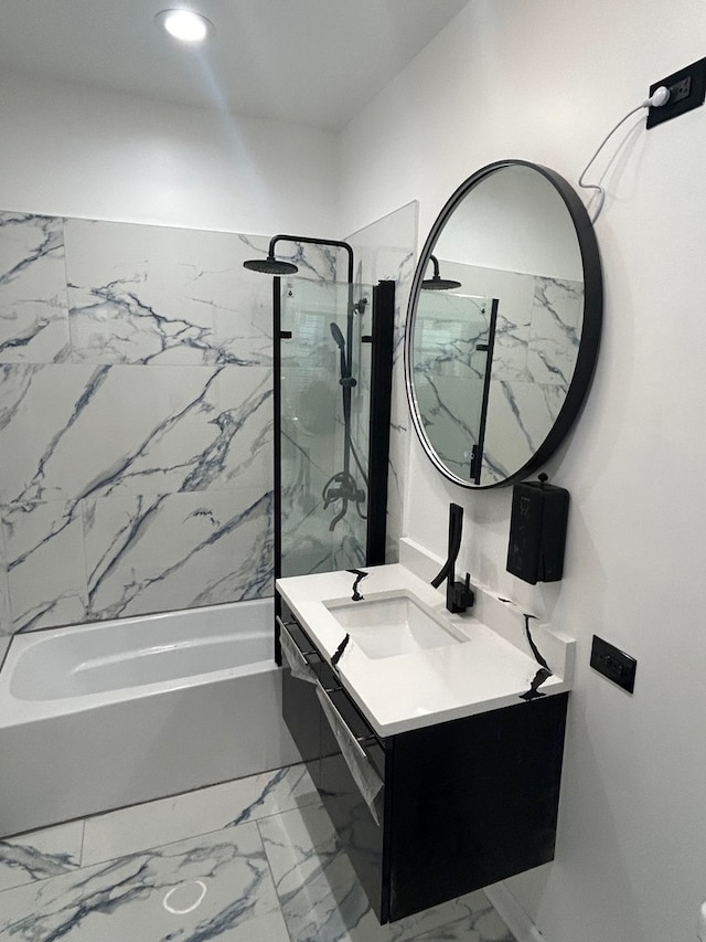 bathroom with vanity and tiled shower / bath