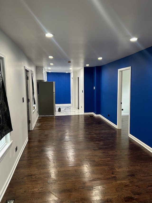 unfurnished living room featuring dark hardwood / wood-style floors