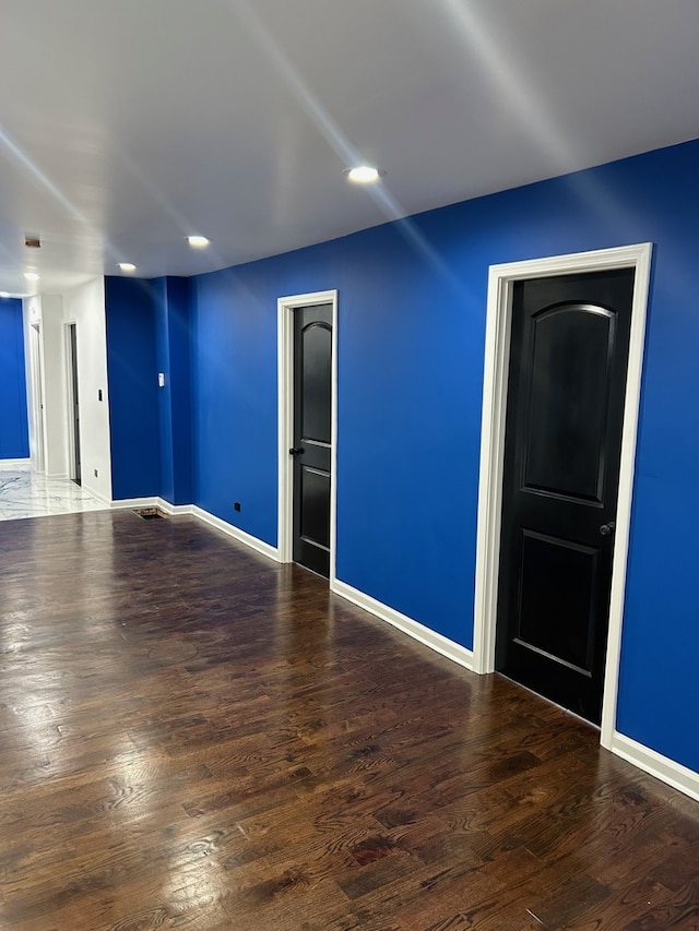 empty room with dark wood-type flooring