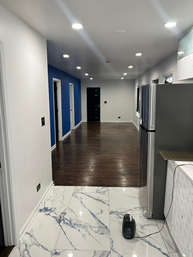 kitchen featuring stainless steel fridge and light hardwood / wood-style floors