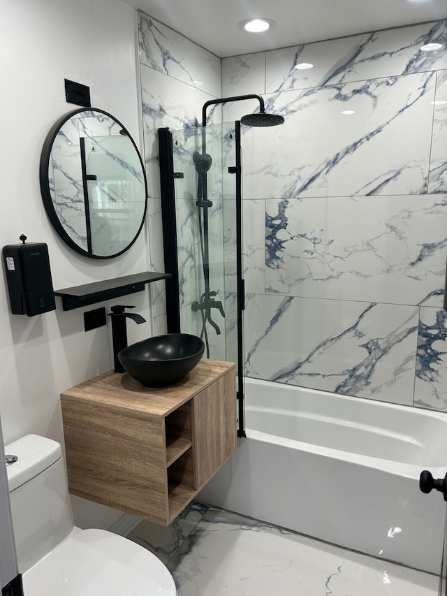 full bathroom featuring vanity, toilet, and tiled shower / bath