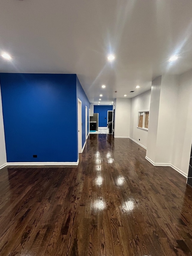 unfurnished living room featuring dark wood-type flooring