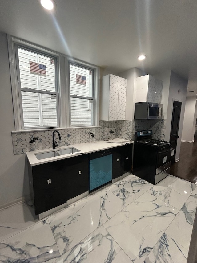 kitchen featuring tasteful backsplash, dishwasher, sink, and range