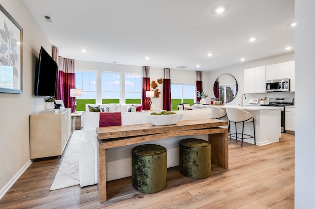 dining area featuring light hardwood / wood-style flooring and sink