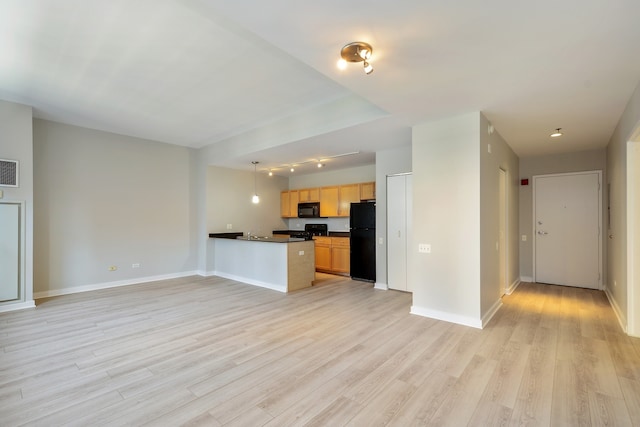 kitchen featuring black appliances, light hardwood / wood-style floors, kitchen peninsula, and sink