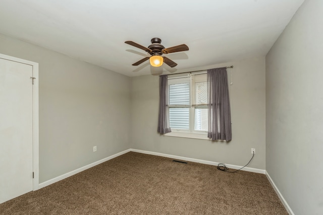 unfurnished room with ceiling fan and carpet