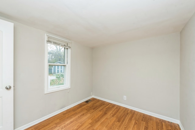 empty room with light hardwood / wood-style flooring