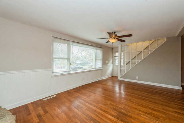 empty room featuring hardwood / wood-style floors and ceiling fan