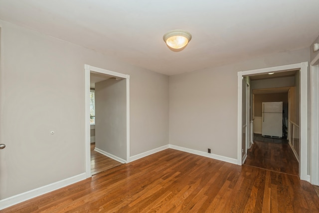 empty room featuring dark hardwood / wood-style flooring