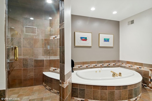 bathroom featuring separate shower and tub