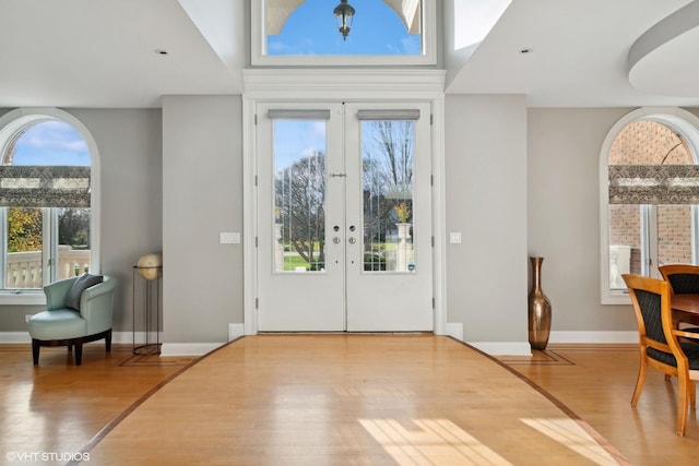 foyer with hardwood / wood-style floors and french doors