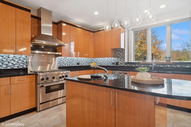 kitchen with backsplash, a kitchen island with sink, stainless steel range, and wall chimney range hood