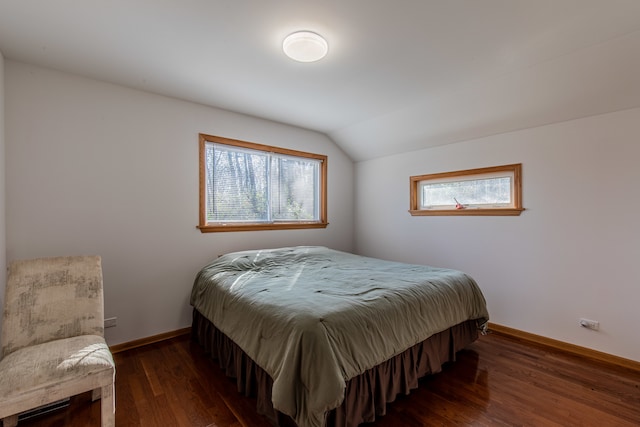 bedroom with vaulted ceiling and dark hardwood / wood-style floors