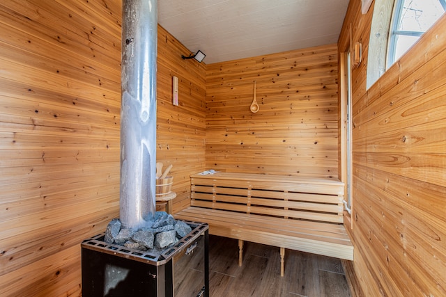 view of sauna featuring hardwood / wood-style floors and wood walls