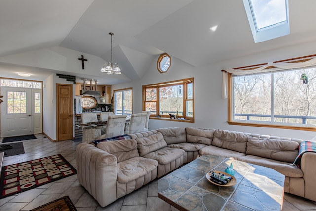 living room featuring lofted ceiling with skylight, light tile patterned floors, and an inviting chandelier