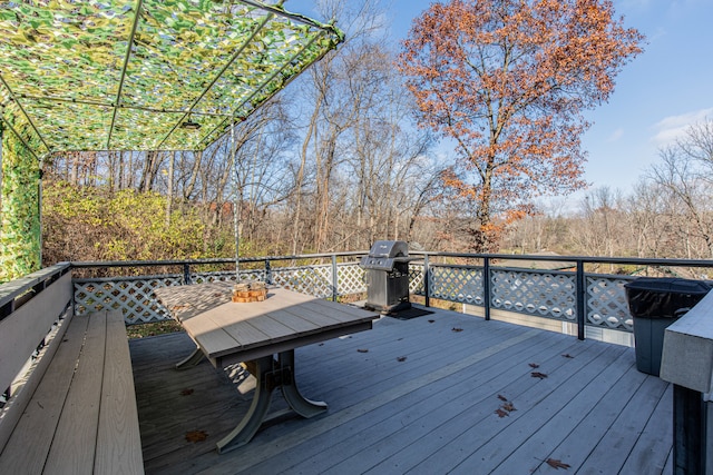 wooden deck featuring a grill