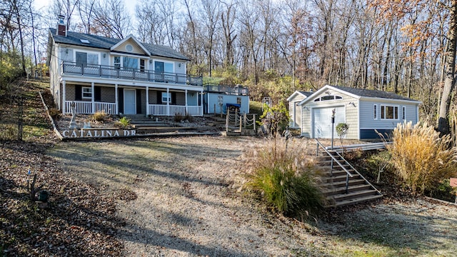 back of property featuring an outbuilding and a garage