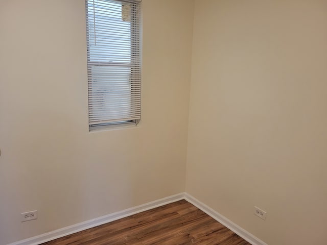 spare room with dark wood-type flooring