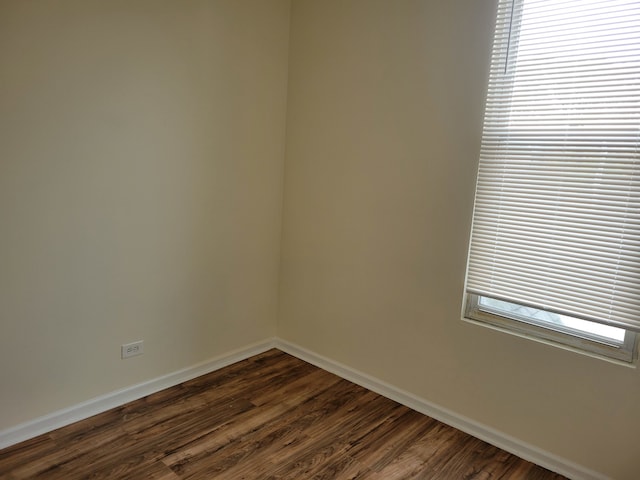 empty room featuring dark hardwood / wood-style floors and a healthy amount of sunlight