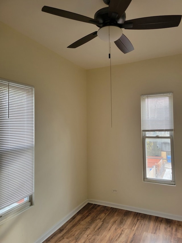 spare room with hardwood / wood-style flooring and ceiling fan