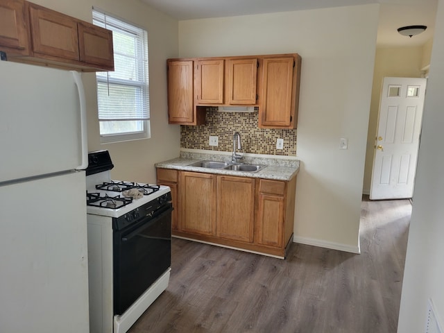 kitchen featuring backsplash, sink, dark wood-type flooring, and white appliances