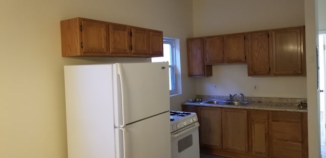 kitchen featuring white appliances and sink