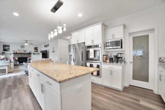 26864 W Wedgewood Ln, Channahon, IL 60410 - kitchen with appliances with stainless steel finishes, open floor plan, a center island, light wood-type flooring, and recessed lighting
