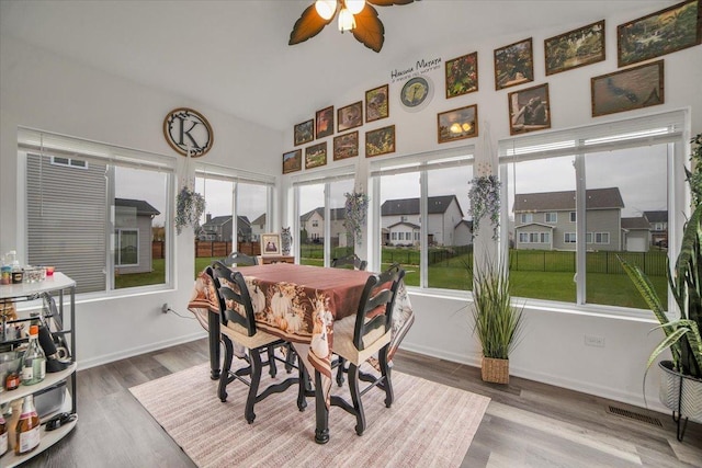 26864 W Wedgewood Ln, Channahon, IL 60410 - sunroom / solarium with healthy amount of natural light, wood finished floors, high vaulted ceiling, and baseboards