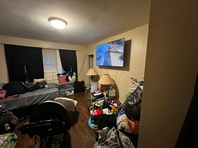 bedroom with dark hardwood / wood-style flooring