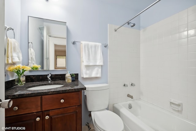 full bathroom with vanity, toilet, and tiled shower / bath