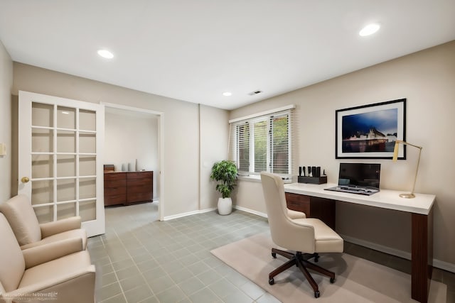 office space with light tile patterned floors and built in desk