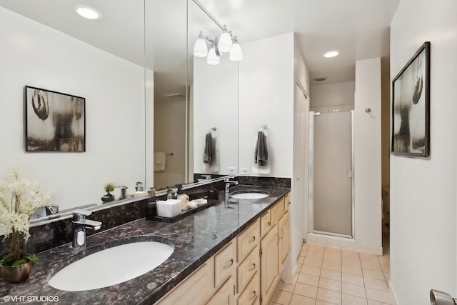 bathroom featuring tile patterned floors, vanity, walk in shower, and a chandelier