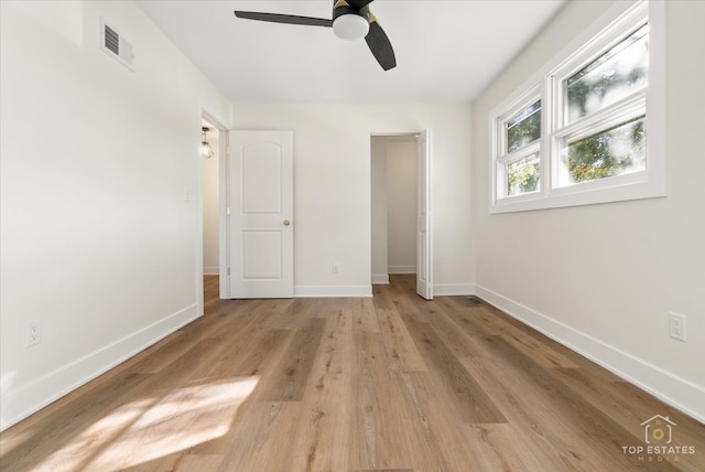 unfurnished bedroom featuring ceiling fan, a closet, and light hardwood / wood-style floors