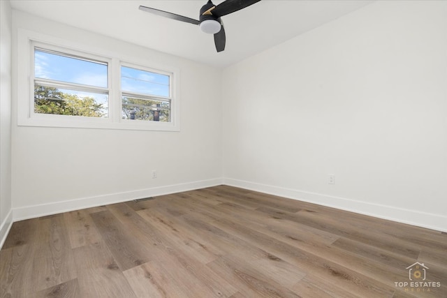 empty room featuring ceiling fan and wood-type flooring