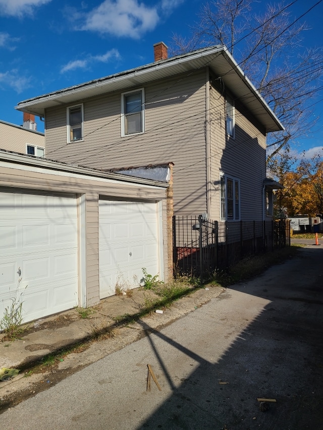 view of side of home with a garage