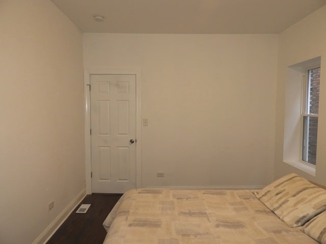 unfurnished bedroom with hardwood / wood-style floors